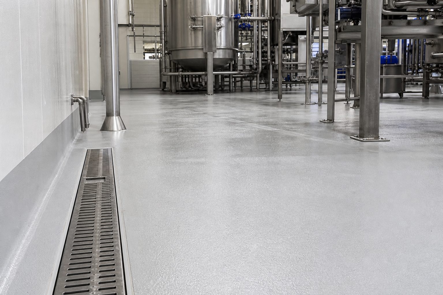 Hygienic polyurethane-cement floor with drains in a food processing facility