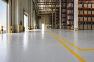 Glossy epoxy floor with safety line marking in a Saudi warehouse