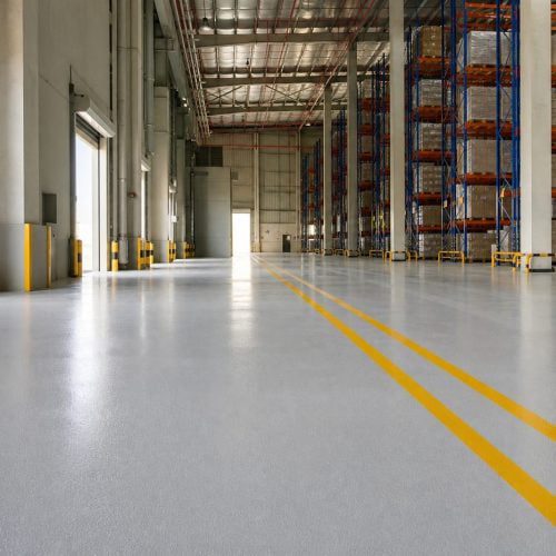 Glossy epoxy floor with safety line marking in a Saudi warehouse