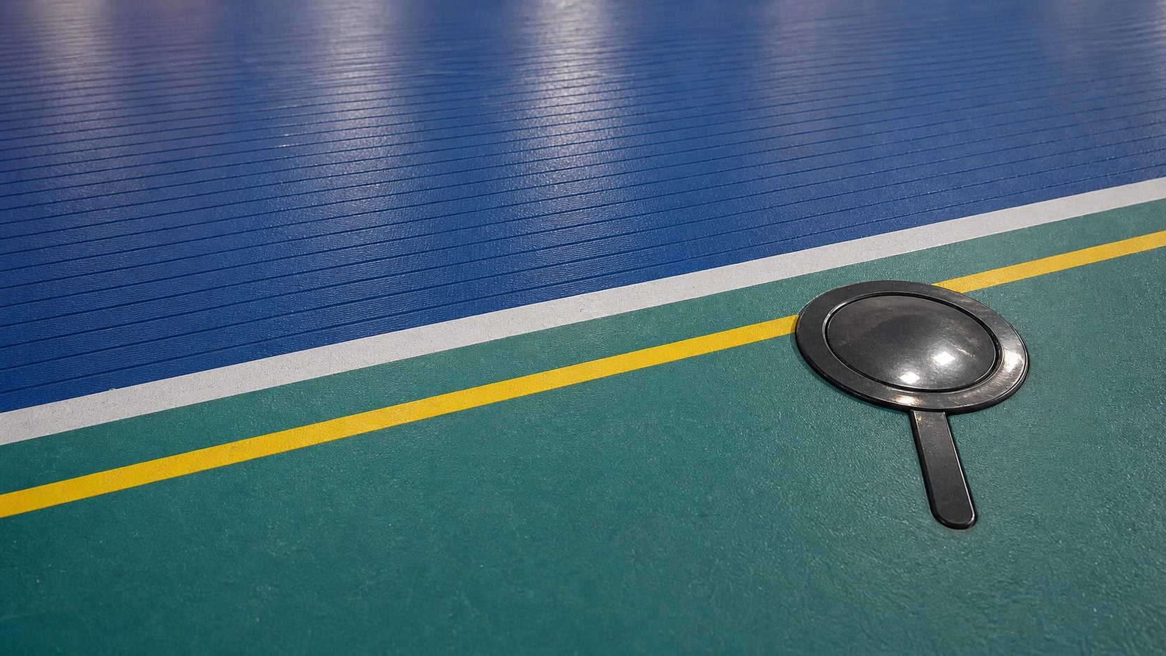 Natural indoor sports flooring with blue ribbed surface teal court area white and yellow lines in Saudi Arabia