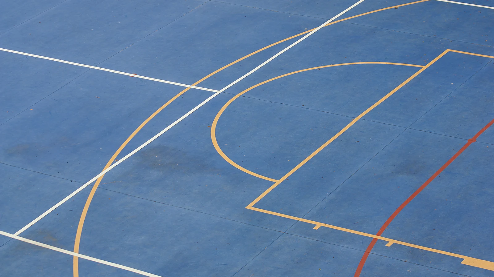 Natural sports court surface detail with line markings for flooring review