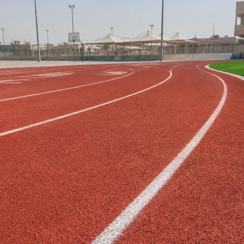 EPDM running track lanes with drainage edge at a Saudi school sports facility
